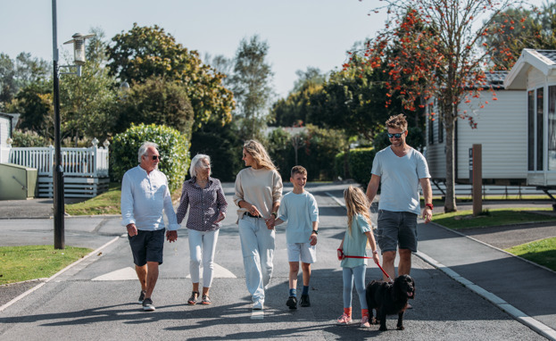 Multi generational family walking through park