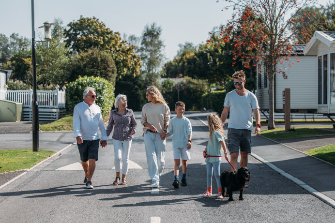 Multi generational family walking through park