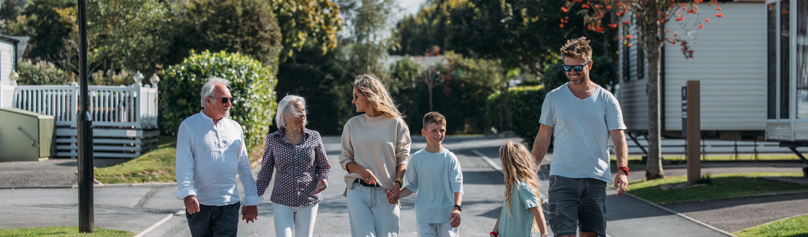 Multi generational family walking through park