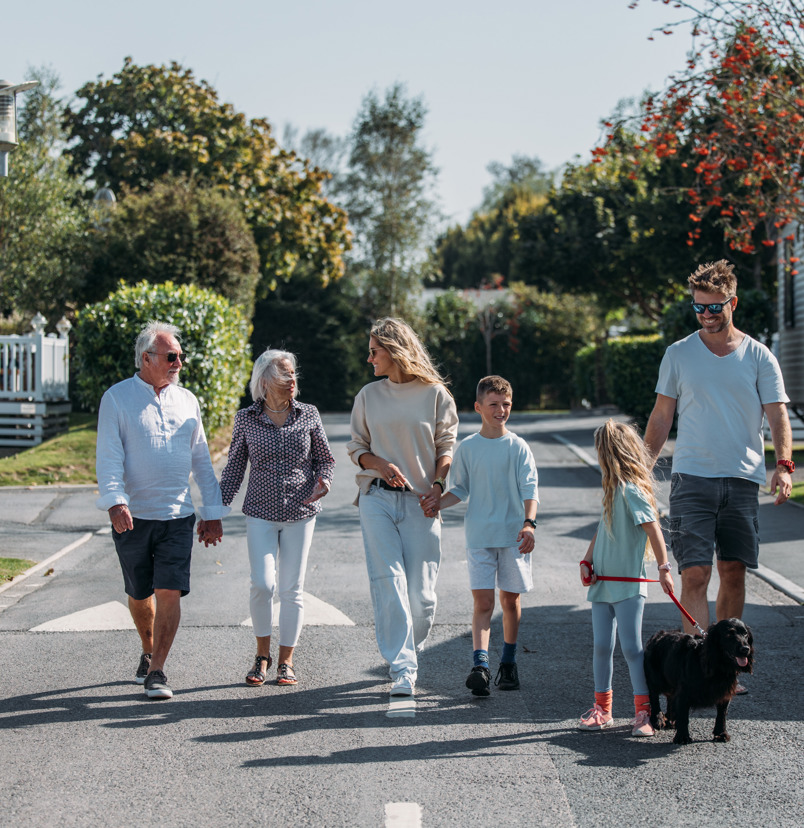 Multi generational family walking through park