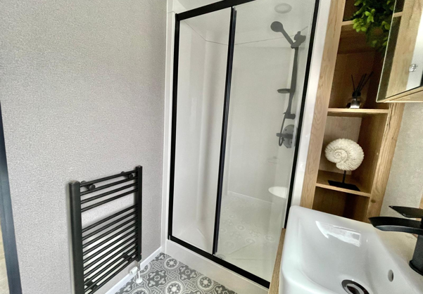 Internal of a caravan bathroom with shower and sink