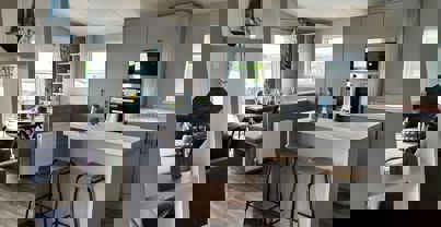 View from entrance across open plan kitchen and dining area