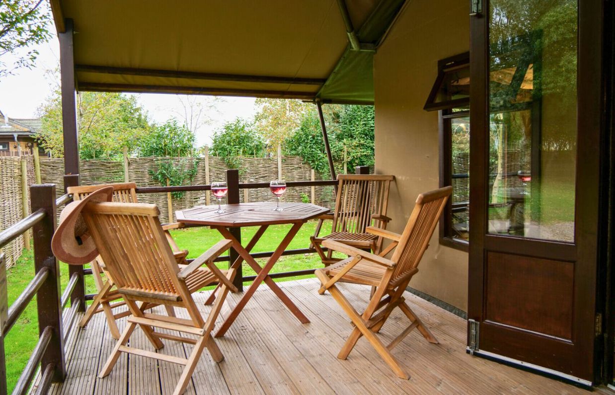 External of safari tent with outdoor furniture and veranda