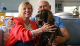 Osmington Owners cuddling dog on sofa