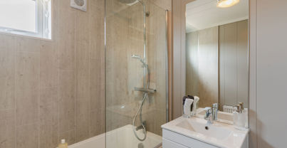 Internal of a luxury lodge bathroom with sink and shower over bath