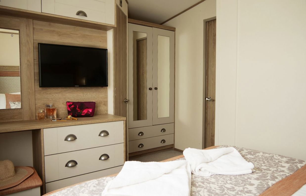 Internal of a caravan master bedroom storage and dressing area