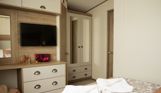Internal of a caravan master bedroom storage and dressing area