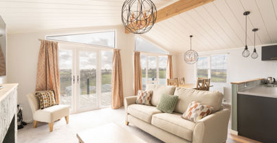 lounge area with sofa armchair and coffee table with large windows and patio doors