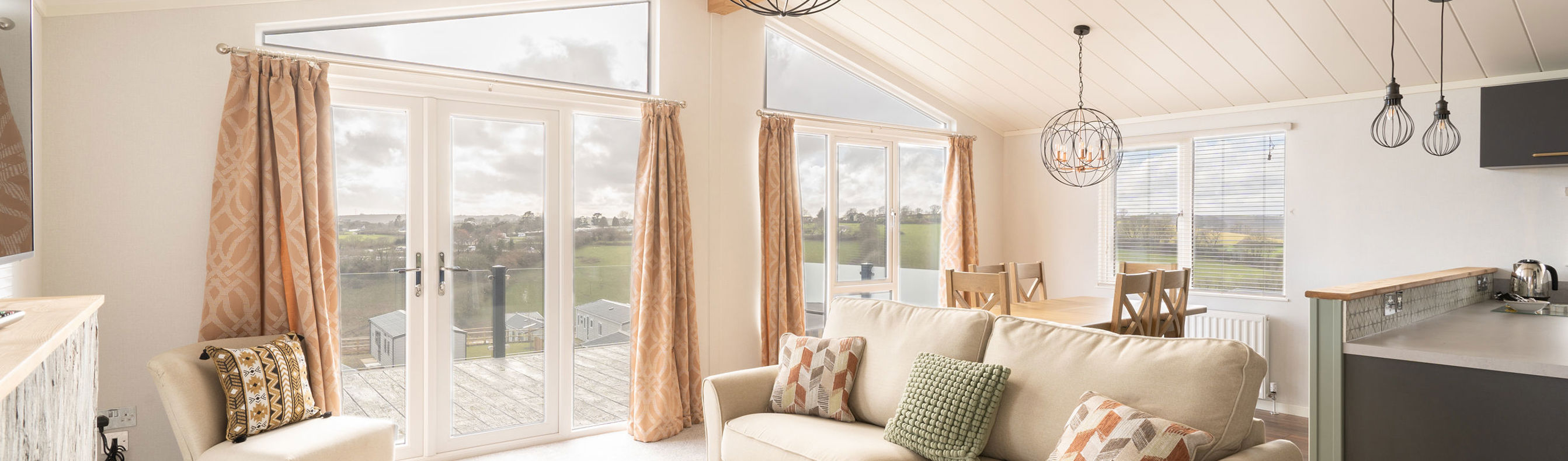 lounge area with sofa armchair and coffee table with large windows and patio doors