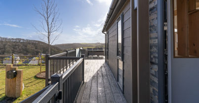 External of lodge looking down the side of the lodge along the decking