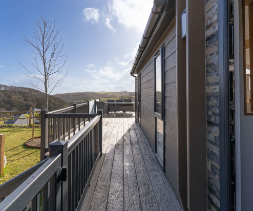 External of lodge looking down the side of the lodge along the decking