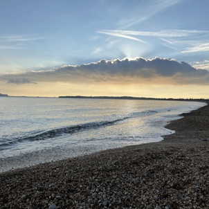 Bowleaze Cove Beach at sunset with dramatic clouds and calm waters