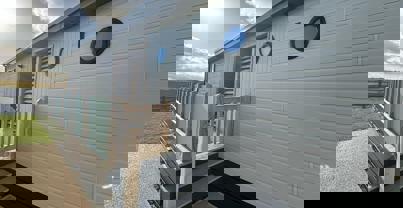 Entrance to lodge decking and side door via stairs