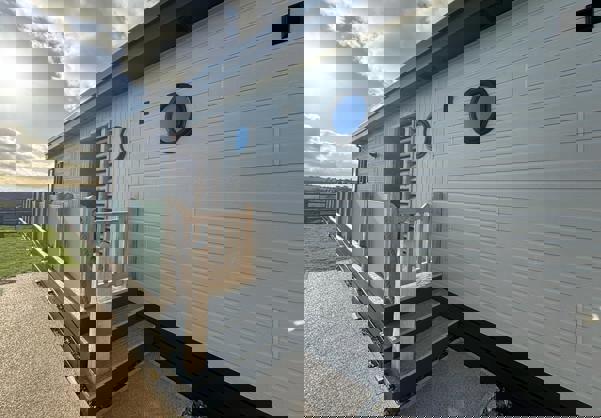 Entrance to lodge decking and side door via stairs