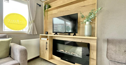 Internal of a caravan lounge with smart TV and electric fire