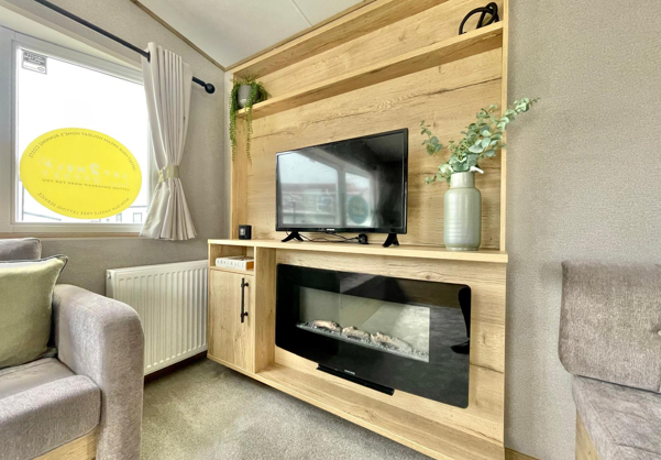 Internal of a caravan lounge with smart TV and electric fire