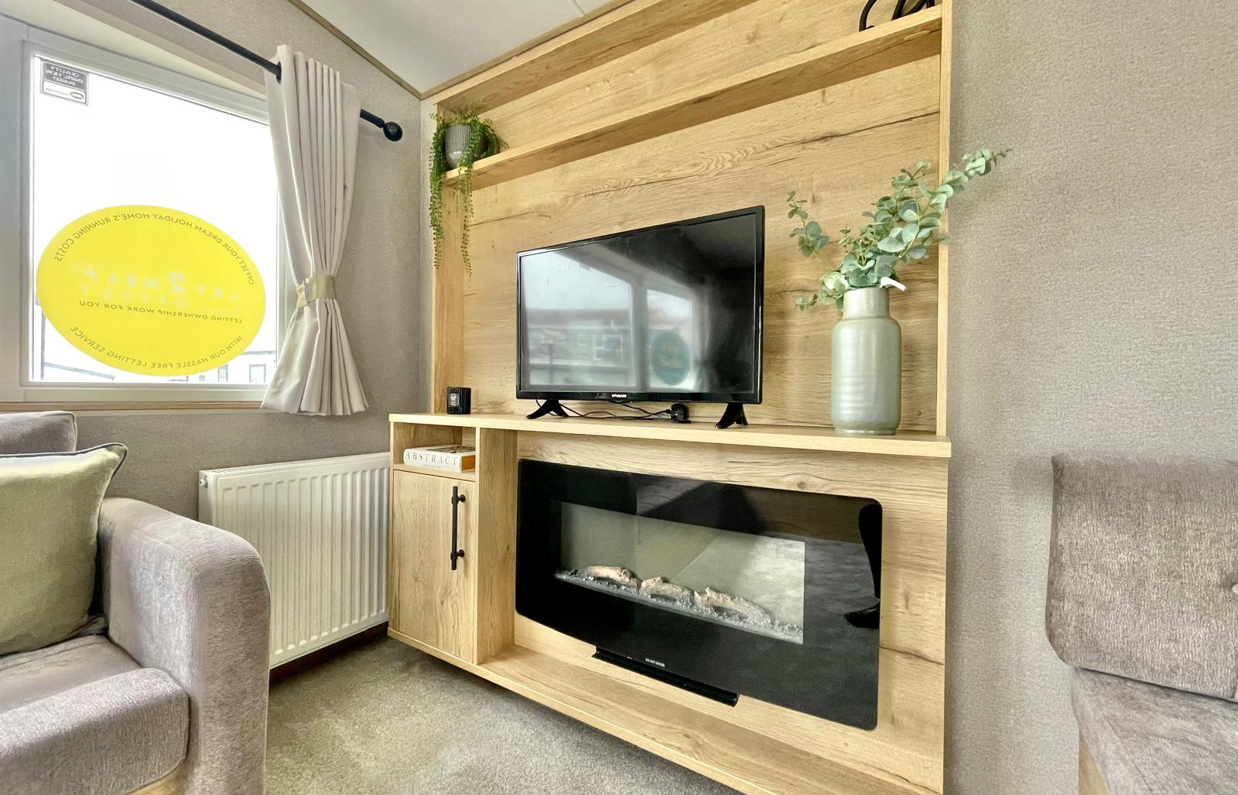 Internal of a caravan lounge with smart TV and electric fire