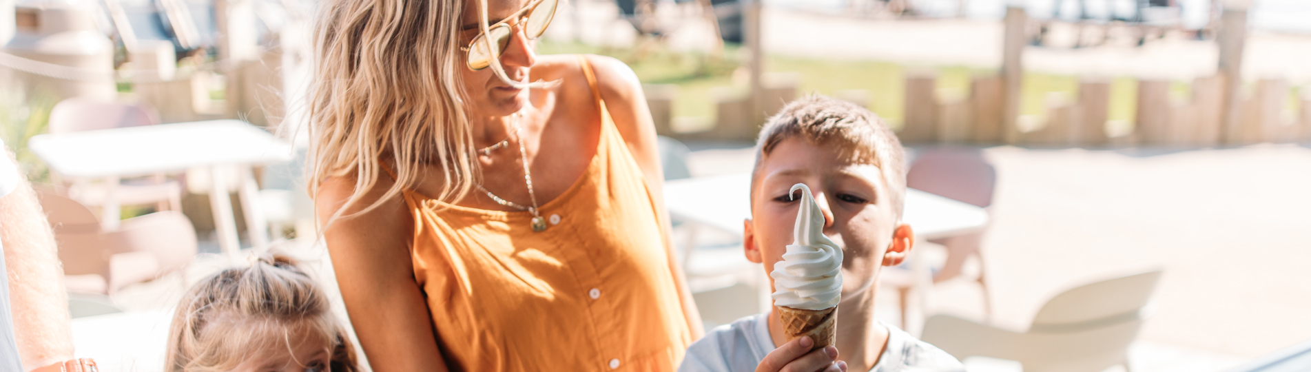 A woman with two young children at an ice cream parlour