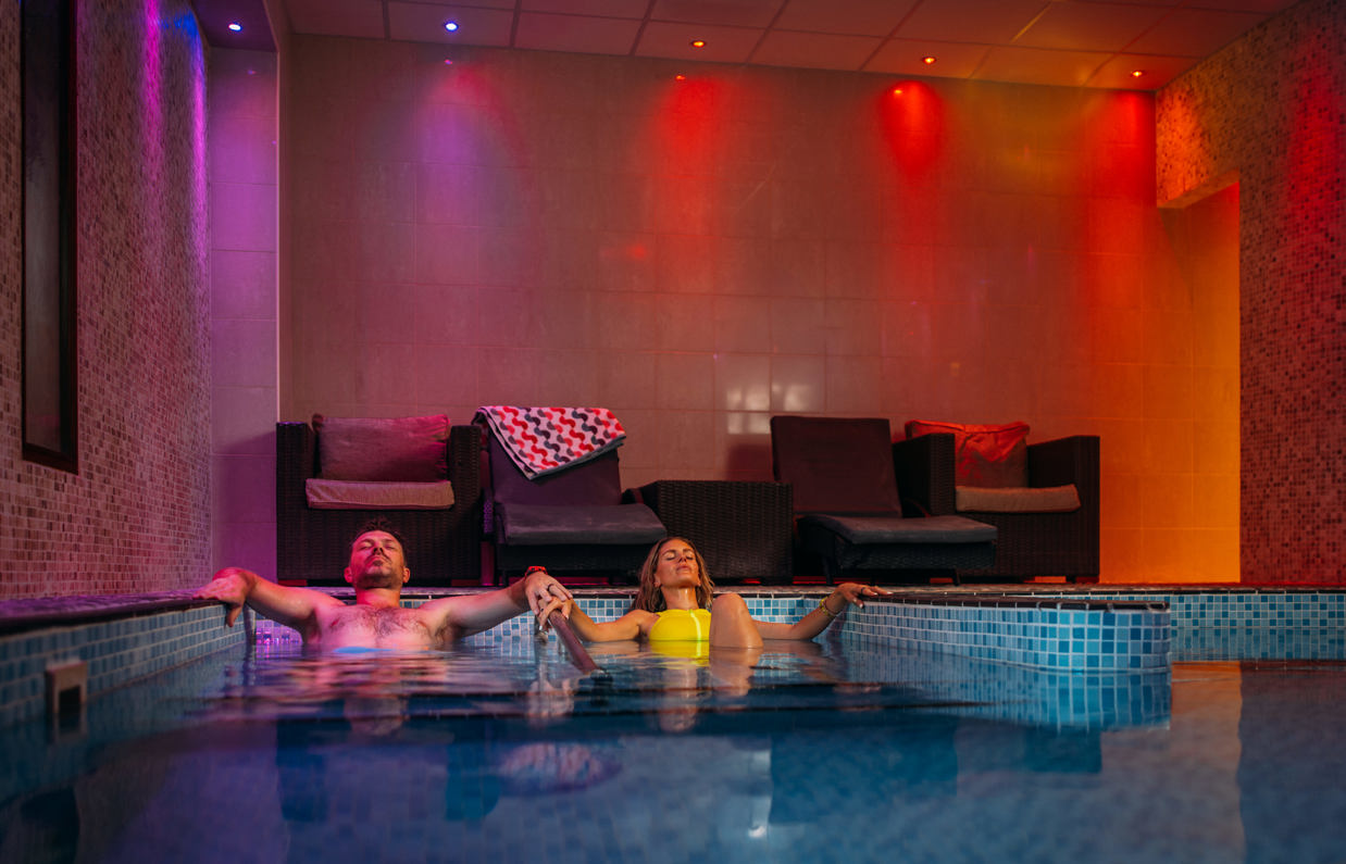 Couple relaxing in the spa at Bowleaze Cove