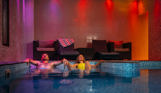 Couple relaxing in the spa at Bowleaze Cove