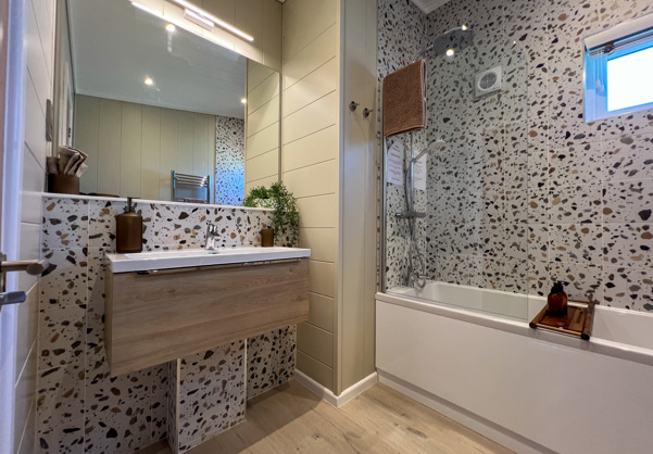 Internal of a luxury lodge bathroom with shower over bath and sink