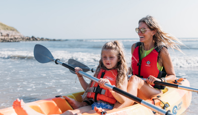 Mother and daughter kayaking in bowleaze cove