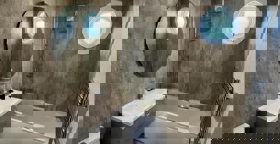 Bathroom with bath tub in light wood floor and concrete style tiles