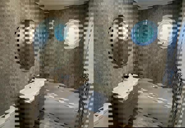 Bathroom with bath tub in light wood floor and concrete style tiles