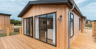 External of a luxury lodge on pitch with decking