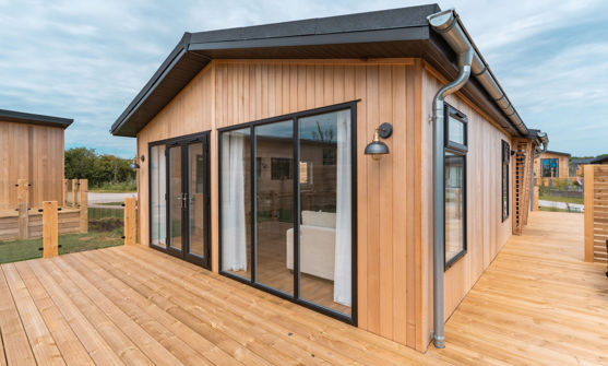 External of a luxury lodge on pitch with decking