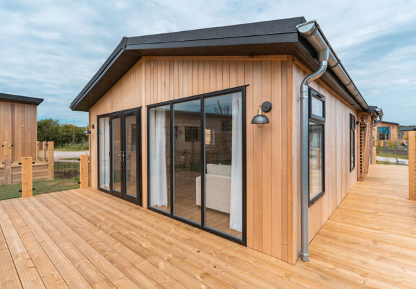 External of a luxury lodge on pitch with decking