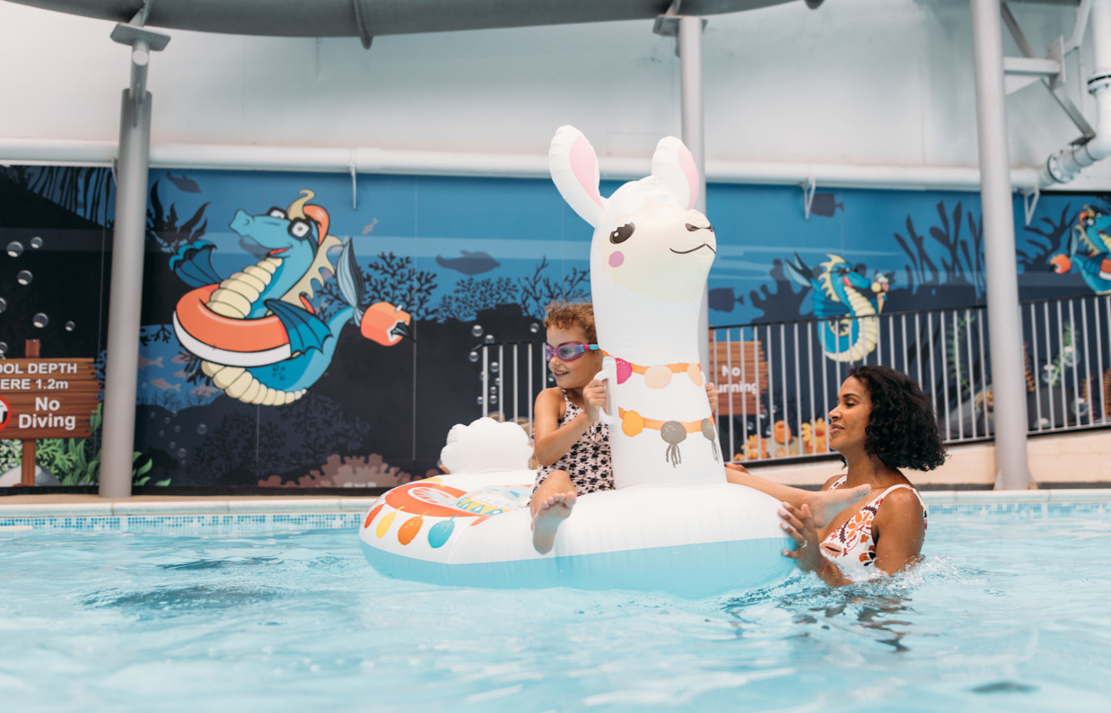 Mother and Daughter playing in swimming pool at Chesil Beach