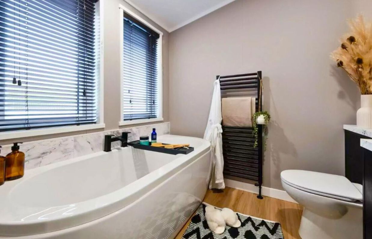 Internal of a lodge bathroom with bath and toilet