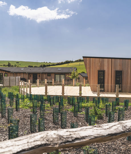 External of a luxury lodge on pitch with decking and countryside views