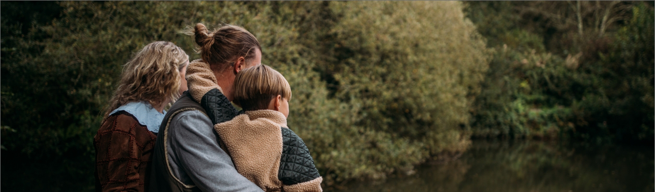 Family looking at fishing lakes from lookout