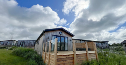 External of a luxury lodge on pitch with decking 