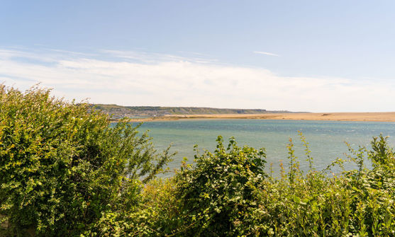 View across lagoon at Chesil Beach towards Portland