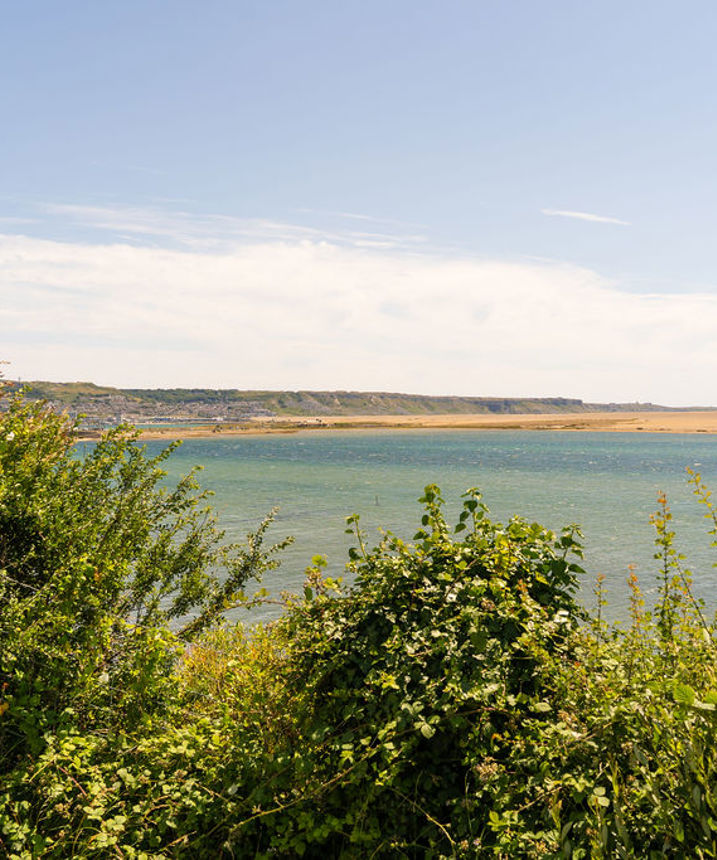 View across lagoon at Chesil Beach towards Portland