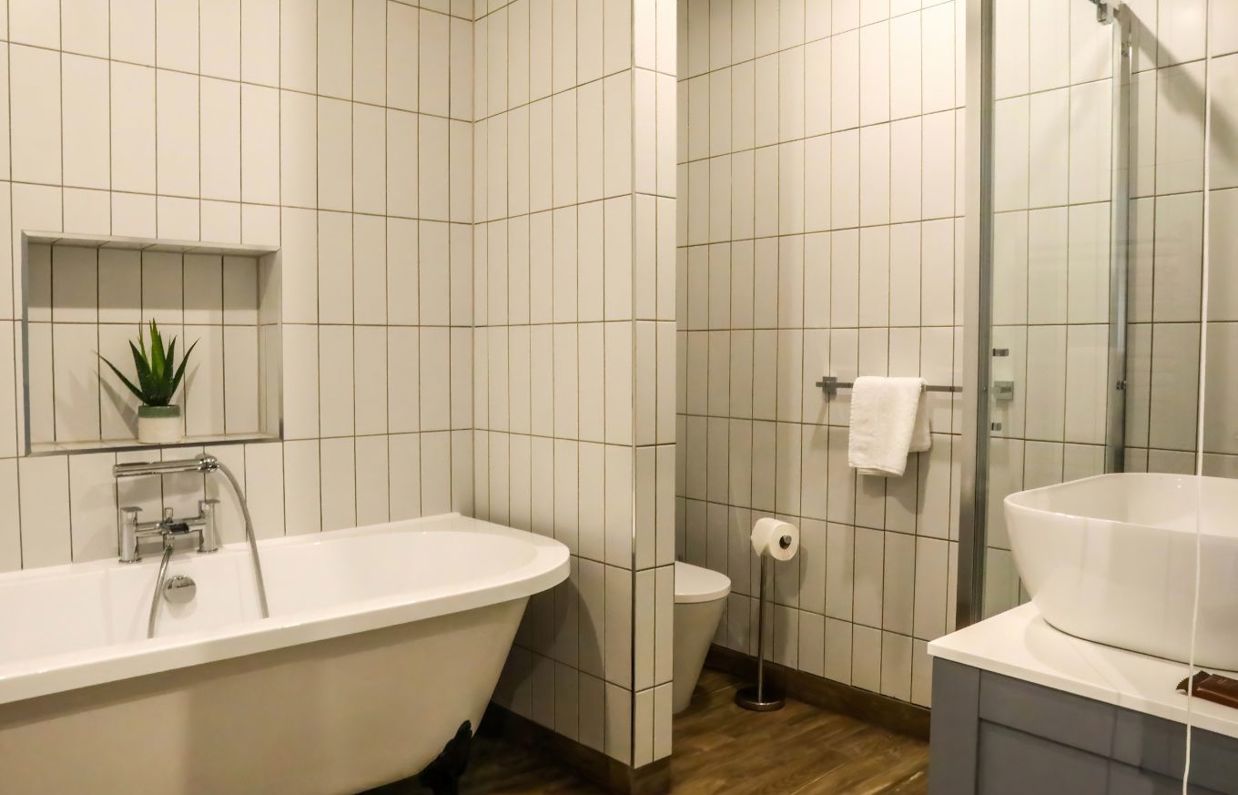 Internal of a manor house bathroom with bath, shower, toilet and sink