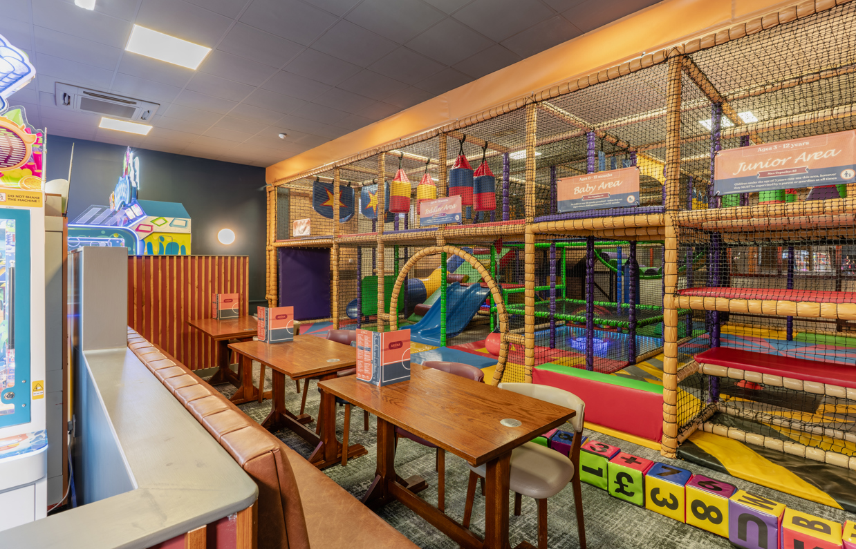 Internal of Arena Sports Bar soft play with adjacent tables and chairs