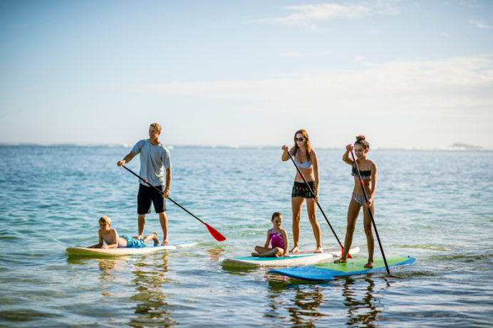 A group of people paddleboarding in the sea