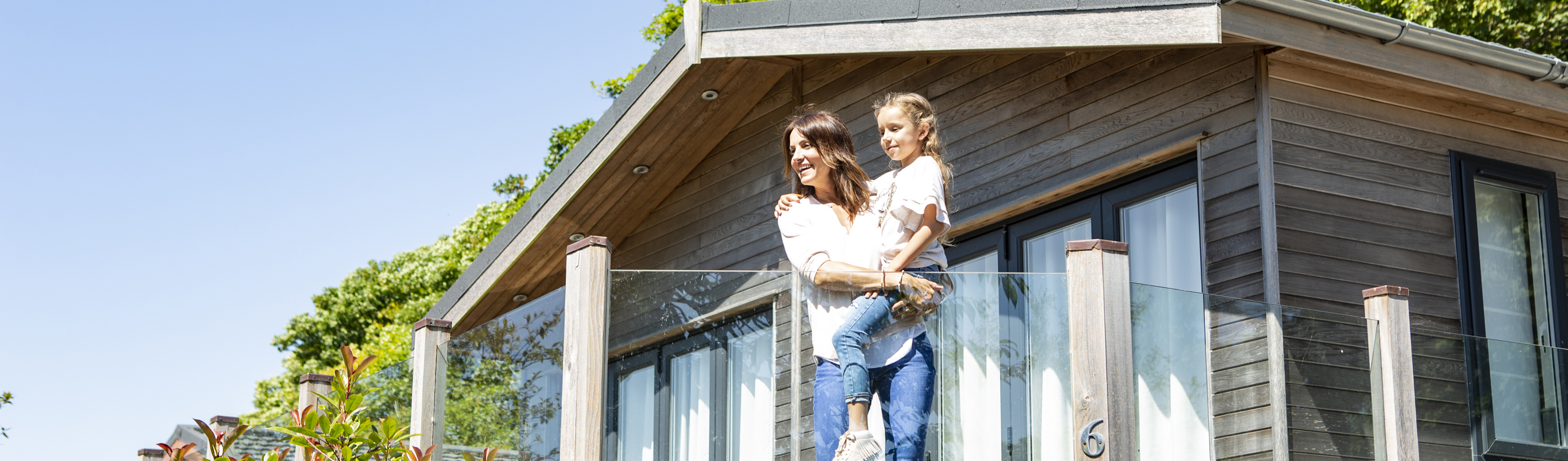 mother and daughter enjoy the view from their holiday lodge