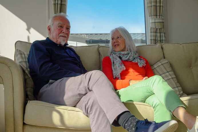 Chesil Beach Owners on sofa and wife looking at husband