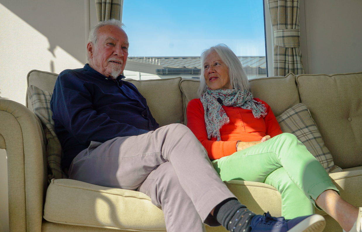 Chesil Beach Owners on sofa and wife looking at husband