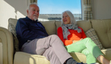 Chesil Beach Owners on sofa and wife looking at husband
