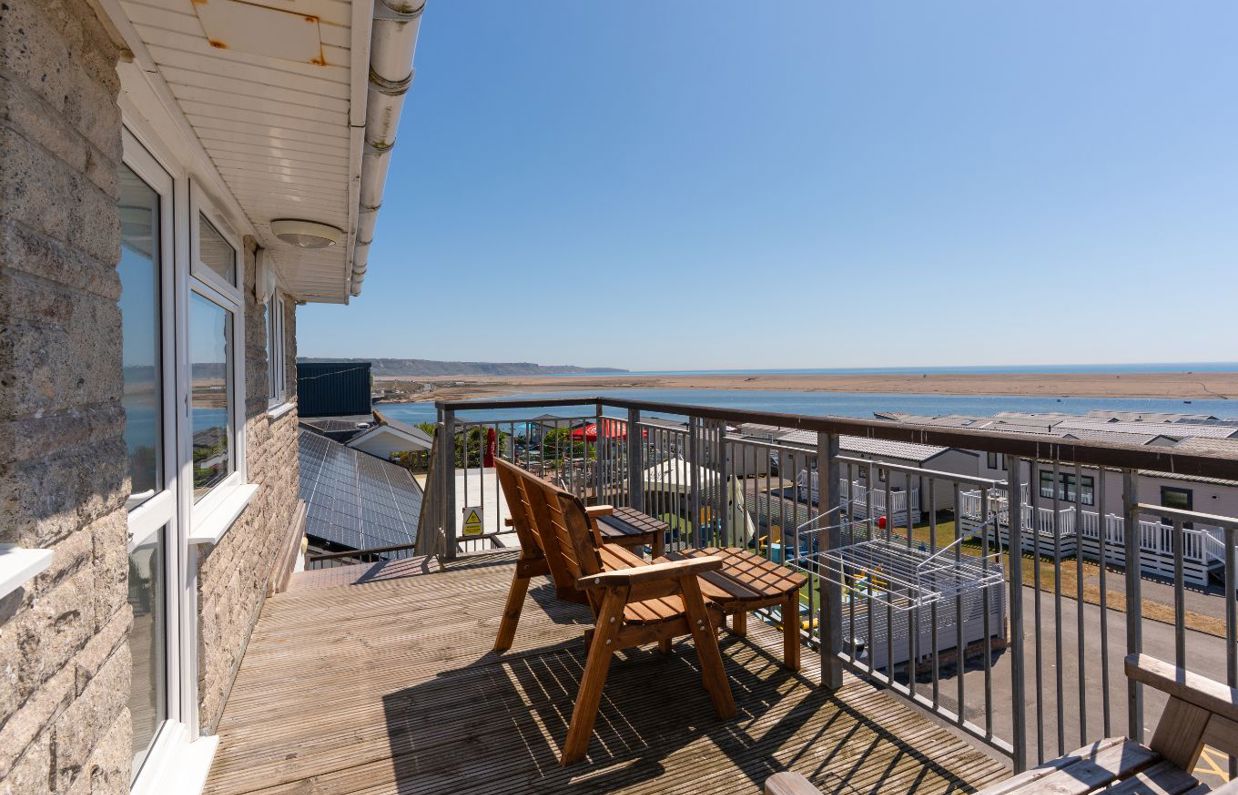 Views of Chesil Beach and the Jurassic Coast from the balcony of Chesil Beach apartments with outdoor furniture