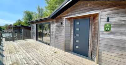 External of a luxury lodge on pitch with decking