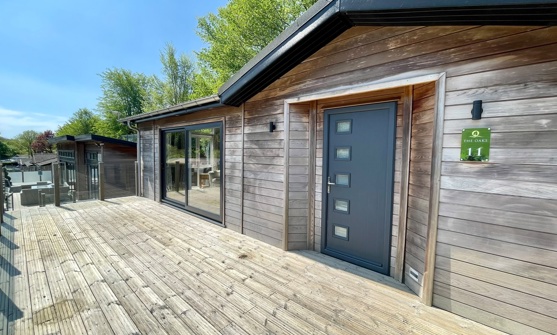 External of a luxury lodge on pitch with decking
