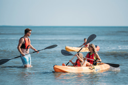Family kayaking in bowleaze cove