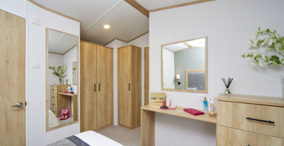 Internal of a caravan master bedroom with dressing area